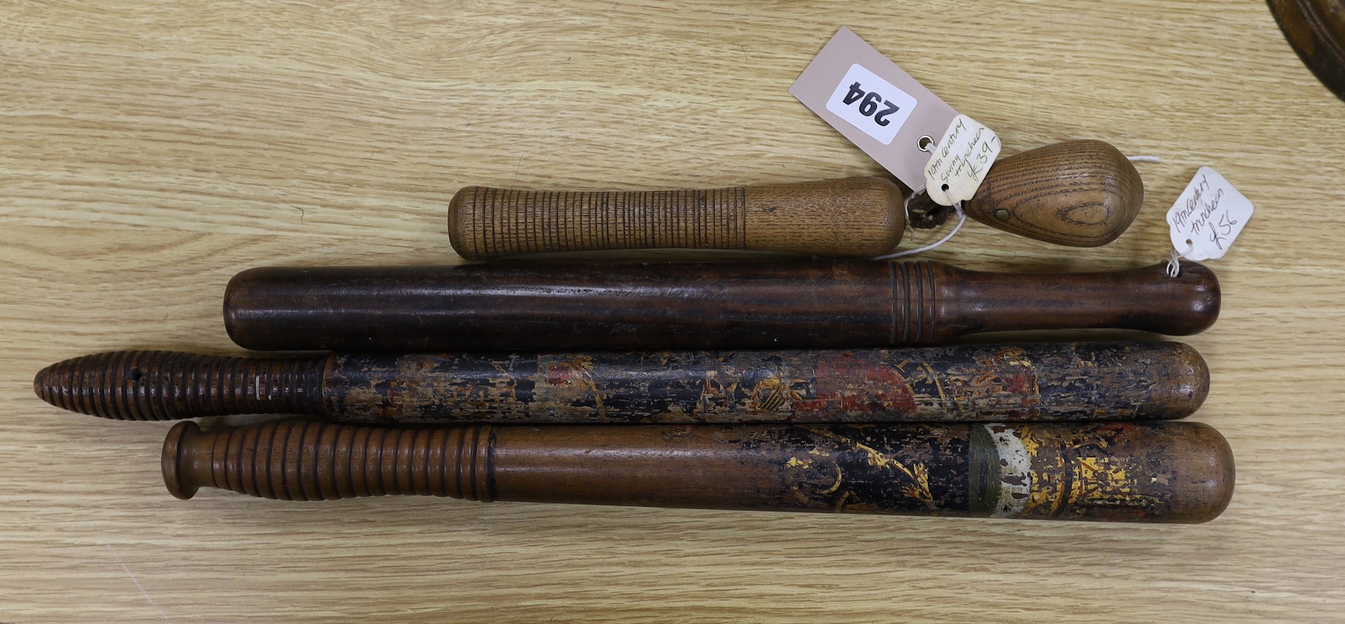 Four 19th century treen truncheons, longest 46cm
